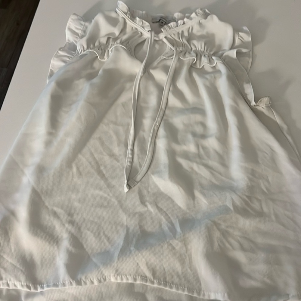 White sleeveless sheer blouse with tie in the front strings
